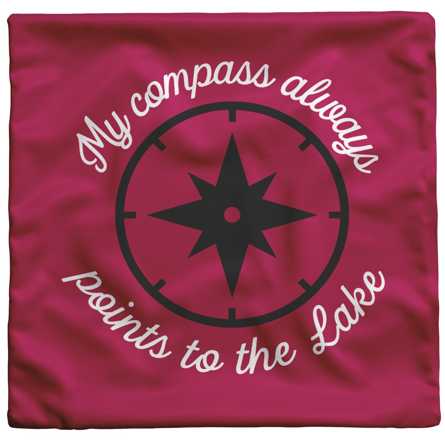 Cranberry pillow cover with script "My compass always points to the lake" in white around a black compass.
